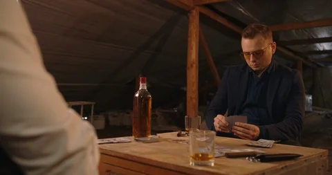 Two angry handsome elegant men talking each other for playing illegal cards game Stock Footage 117678385