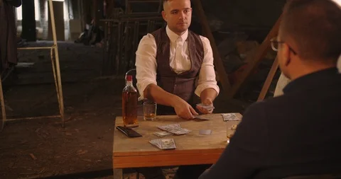 Two angry handsome elegant men talking each other for playing illegal cards game Stock Footage 117679702