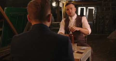 Two angry handsome elegant men talking each other for playing illegal cards game Stock Footage 117682554