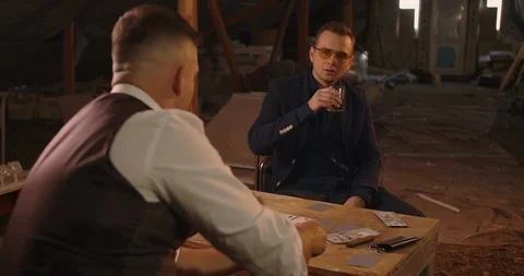 Two angry handsome elegant men talking each other for playing illegal cards game Stock Footage 117682587