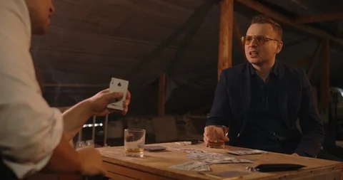 Two angry handsome elegant men talking each other for playing illegal cards game Stock Footage 117683882