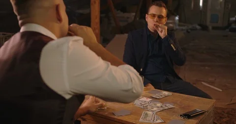 Two angry handsome elegant men talking each other for playing illegal cards game Stock Footage 117683985