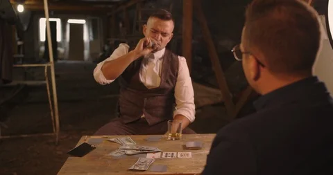 Two angry handsome elegant men talking each other for playing illegal cards game Stock Footage 117684073