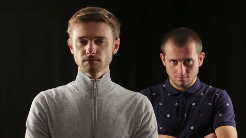 Two angry man point gun to the viewer and shoot Stock Footage 70412052