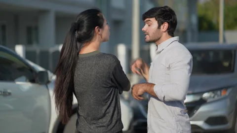 Two angry motorists arguing after a car accident on the road calling insuranc Stock Footage 147340130
