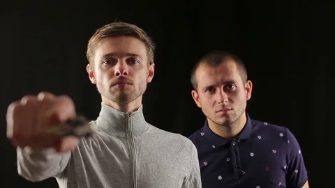 Two angry robbers points gun at the viewer Stock Footage 82919249