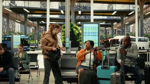 Two angry women fighting in crowded bus station waiting area Stock Footage 334724143