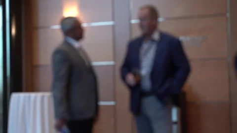 Two anonymous business men chatting and networking at a conference Stock Footage 252153507