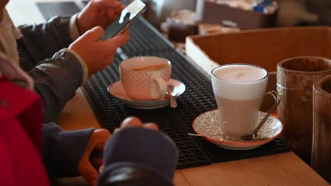 Two anonymous girls chat at the bar while they drink at the counter Stock Footage 162759321