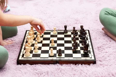 Two anonymous unrecognizable school age children, little girls playing chess  Stock Photos