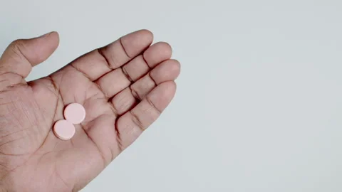 Two Antacid Pills In Hand Stock Footage 248755980