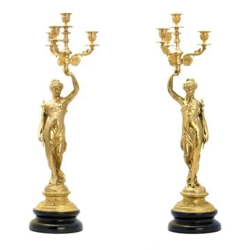 Two antique golden candlesticks in the shape of female figures. Isolated picture Stock Photos
