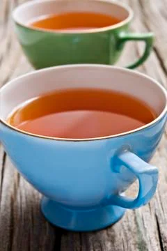 Two antiques cups with tea Stock Photos