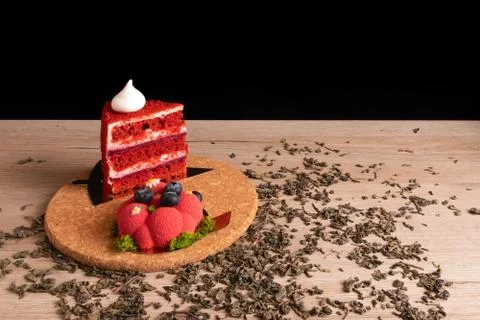 Two appetizing delicious red cakes on a cork stand Stock Photos
