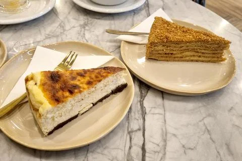 Two appetizing slices of cake are elegantly served on a marble table. a class Stock Photos