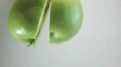 Two apple halfs plung into water Stock Footage 63053051