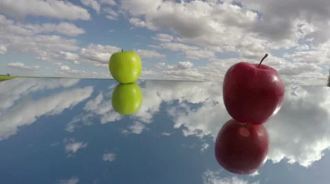 Two apple on mirror and clouds. Time concept timelapse 4K Stock Footage 50276508