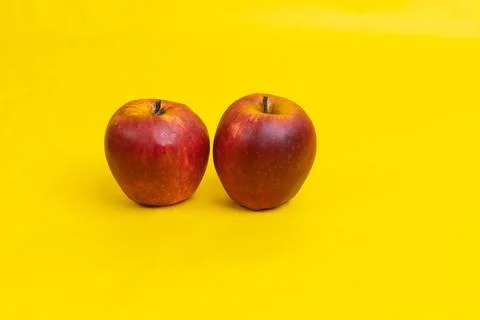 Two apple on yellow background Stock Photos