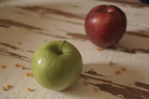 Two apples on aged, white barn woon backdrop. Stock Photos