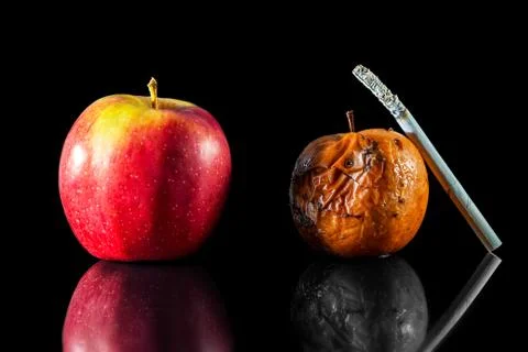 Two apples and a cigarette Stock Photos
