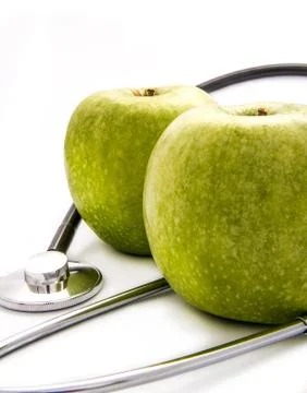 Two apples and stethoscope Stock Photos