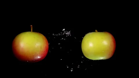Two apples are hitting each other on the black background Stock Footage 302848678