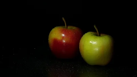 Two apples on a dark background. A drop of water flows down the apple. Stock Footage 84905818