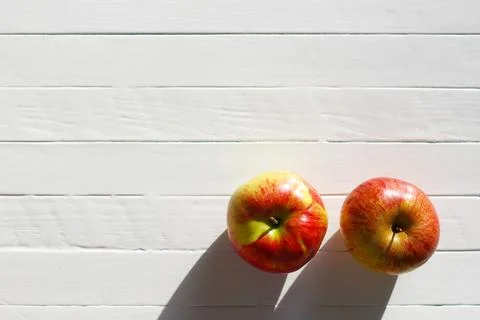 Two apples on a white table, copy space for text Stock Photos