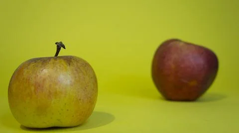 Two apples on a yellow background, two fruits Stock Photos