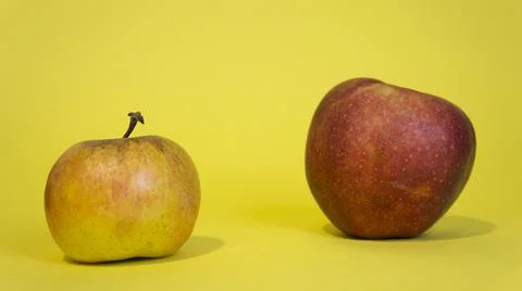 Two apples on a yellow background, two fruits Stock Photos