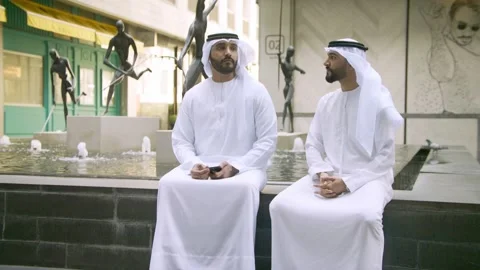 Two arab man sitting in front of a fountain. Stock Footage 237078077