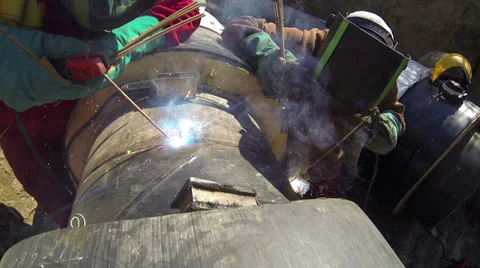 Two Arc Welders Working in a Pipeline Stock Footage 30358894