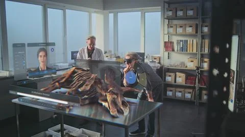 Two archaeologists in VR headsets using virtual AI assistant and web browser Stock Photos