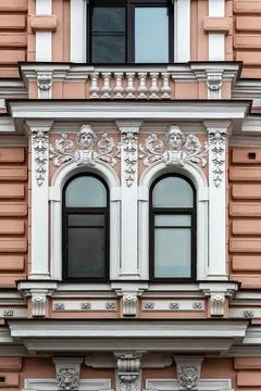 Two arched windows with bas-relief. Stock Photos