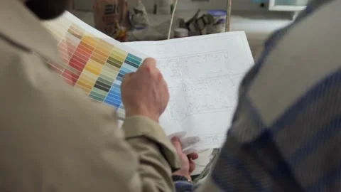 Two architects are holding drawings and a color palette in their hands Stock Footage 234445490