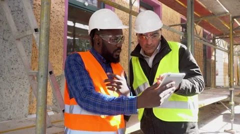 Two architects on construction site among scaffolding Stock Footage 62530078
