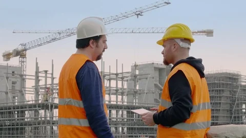 Two architects on construction site photographing with the tablet work Stock Footage 72630130