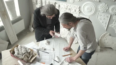 Two architects restorers are working with creative project standing in bright Stock Footage 92324715