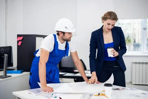 Two architects working with a chart in a bright office Stock Photos