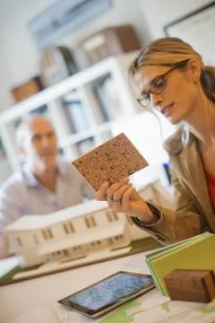 Two architects working on a green construction project, using computer techno Stock Photos