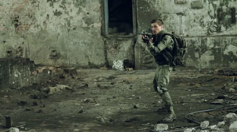 Two armed men in military uniforms were exchanging fire in the hall of an Stock Footage 67170683
