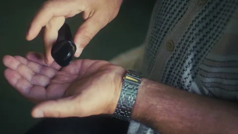 Two arms and a small round container. capsules or tablets are poured out. Stock Footage 316516372