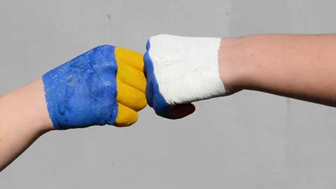 Two arms painted in colors of flags Ukraine russia, two fists ,consept of battle Stock Footage 172366891