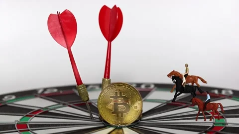 Two arrowheads and Bitcoin on a dart board with three miniature men riding horse Stock Footage 288405558