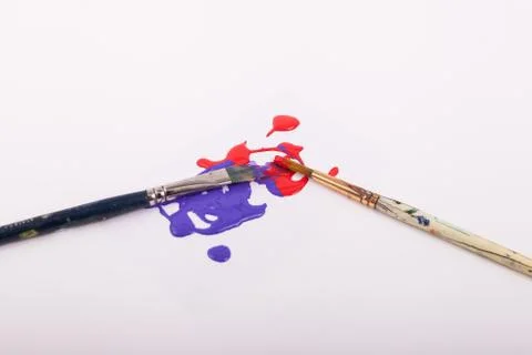 Two art paint brushes with paint splatter Stock Photos