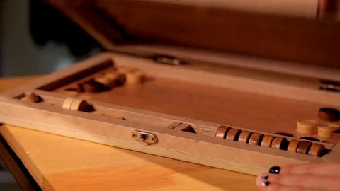 Two artistic girls play backgammon in a restaurant Stockbeeldmateriaal 80844185