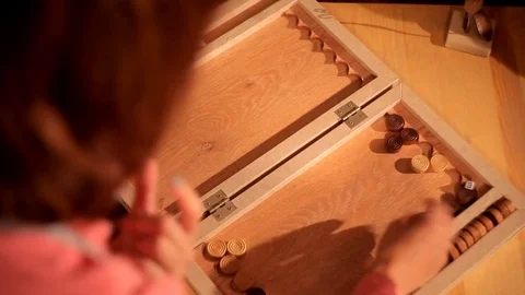 Two artistic girls play backgammon in a restaurant Stock Footage 80844312