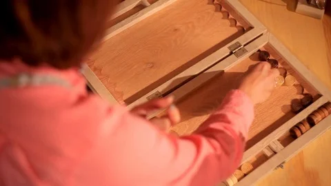 Two artistic girls play backgammon in a restaurant Stock Footage 80844373