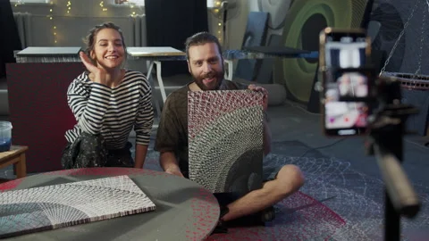 Two artists are telling about a picture on a video Video stock 155557834