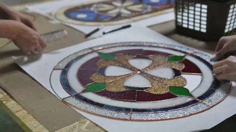 Two artists assemble a composition from stained glass details. Hands of two Stock Footage 161407815